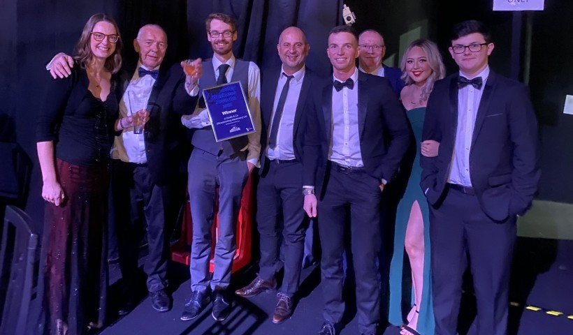 A team photo holding an award